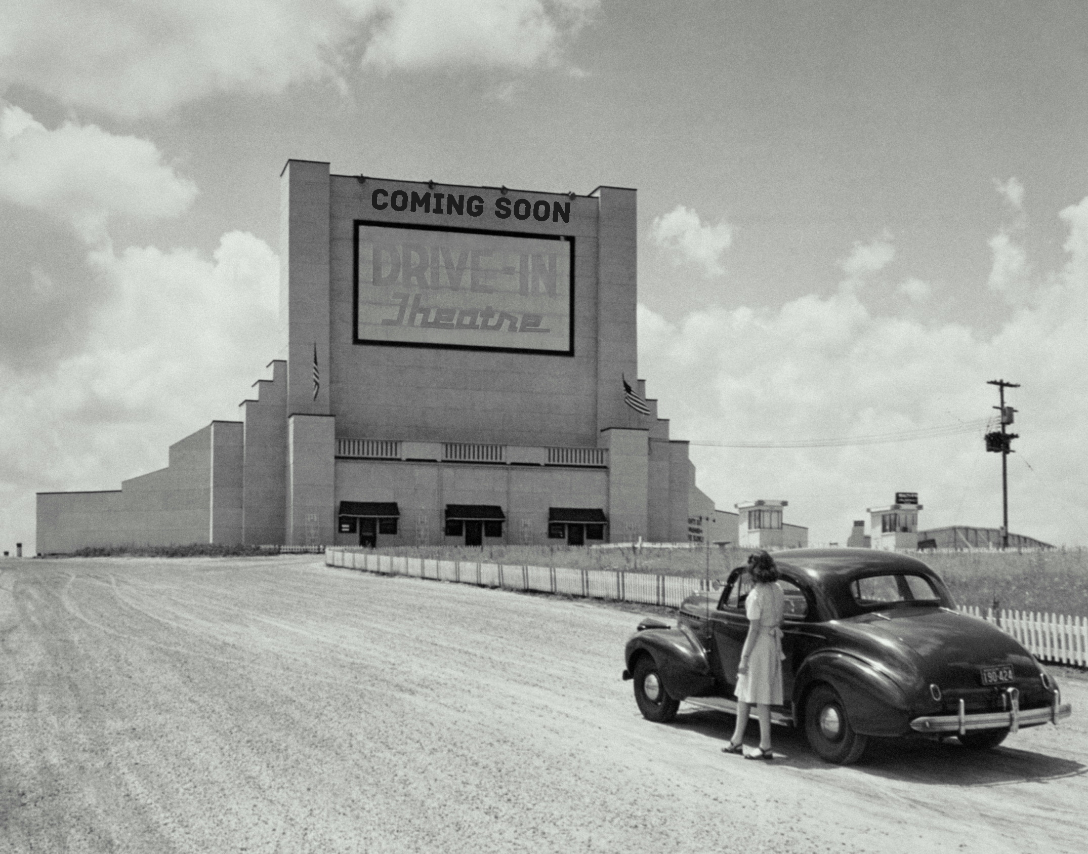 Person waiting outside vehicle near Drive In Movie