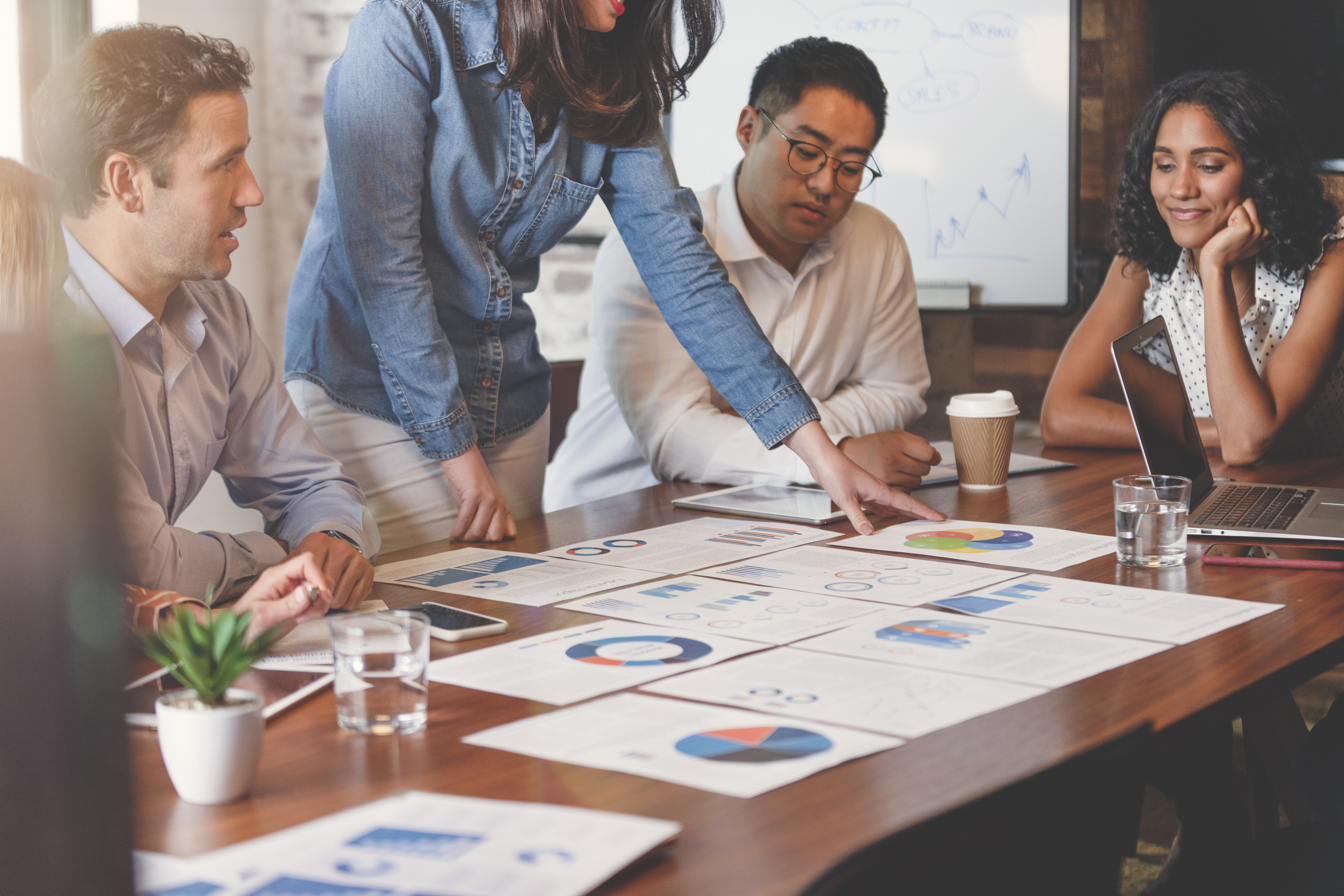 Several people gathered around a table with facts 