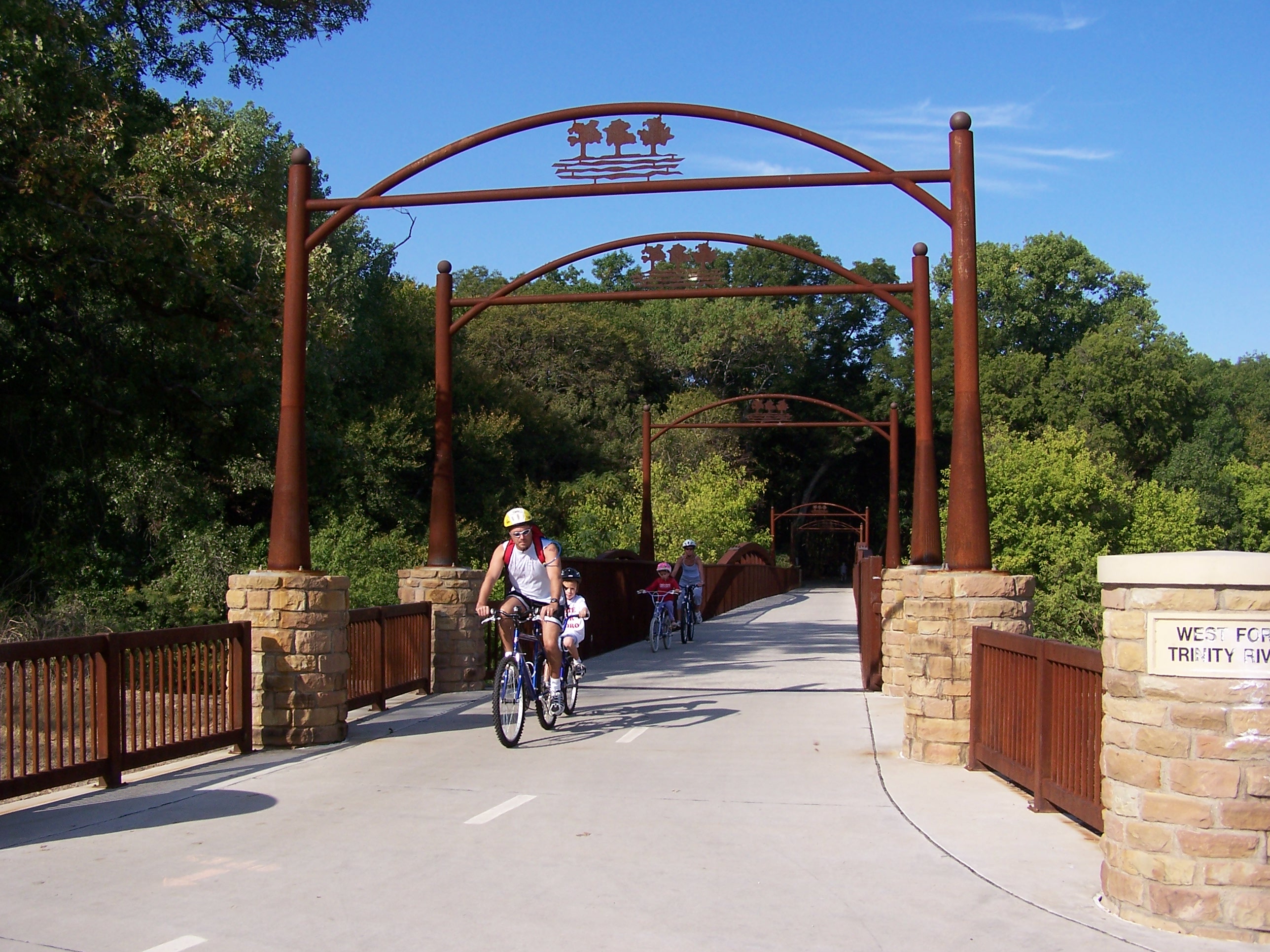 Arlington Texas bicyclers moving through a bridge