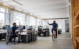 Man riding bicycle in office