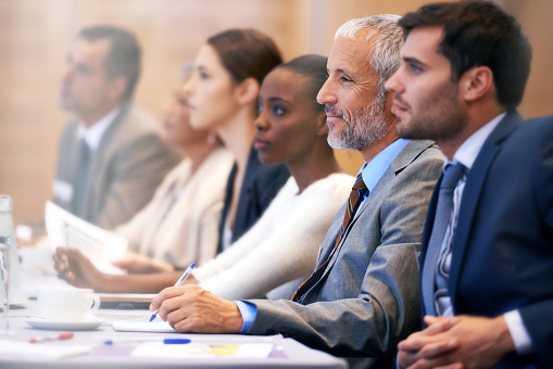 This is an image of a group of people gathered at a desk