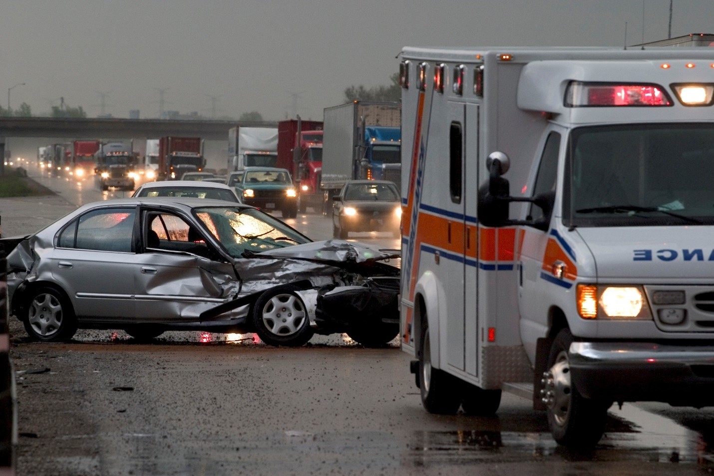 vehicle accident scene showing car wreck with ambulance