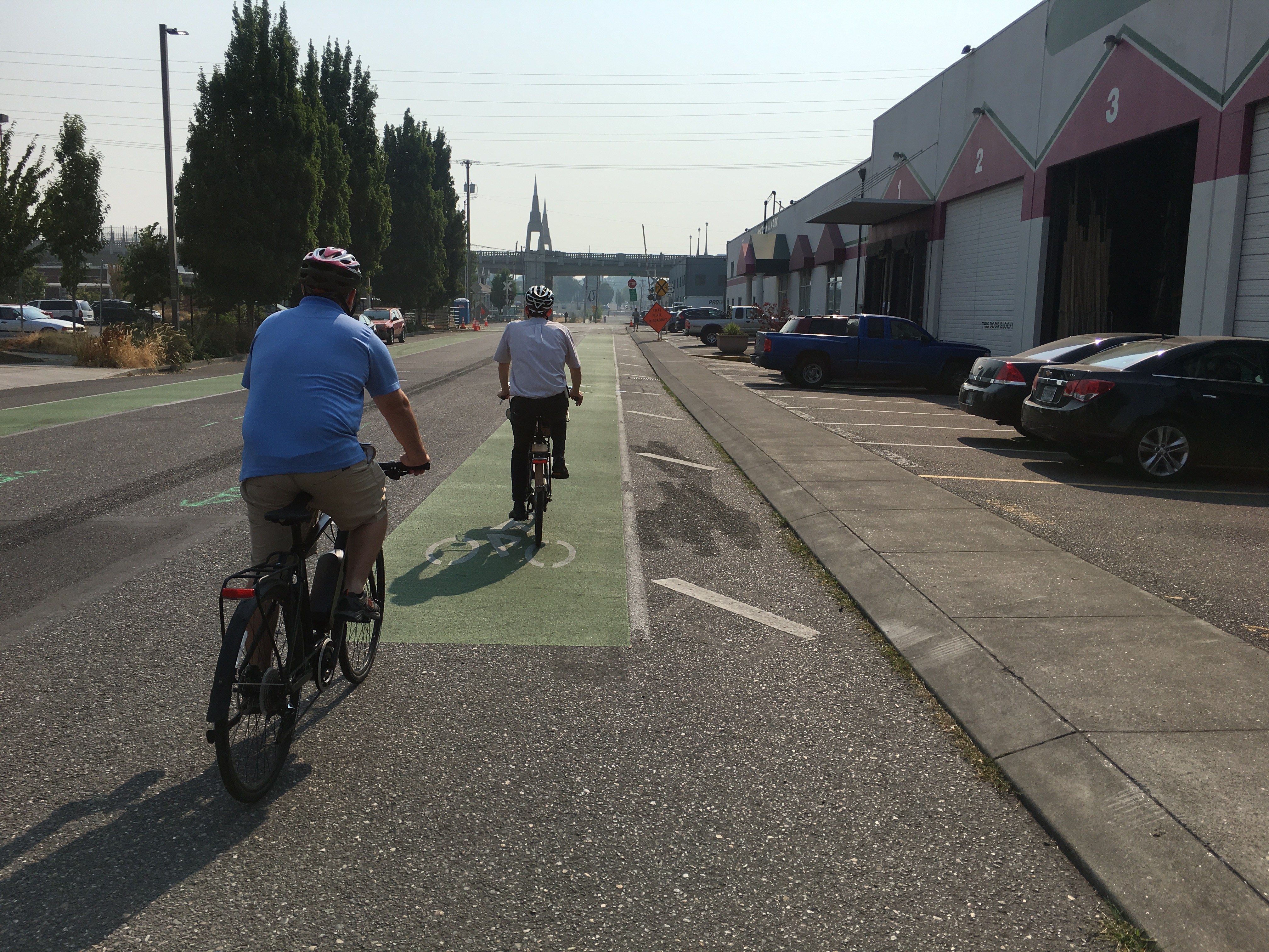 Two people riding a bike in a lane