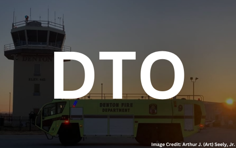 Aircraft Rescue and Fire Fighting Truck with Air Traffic Control Tower in the background at Denton Enterprise Airport