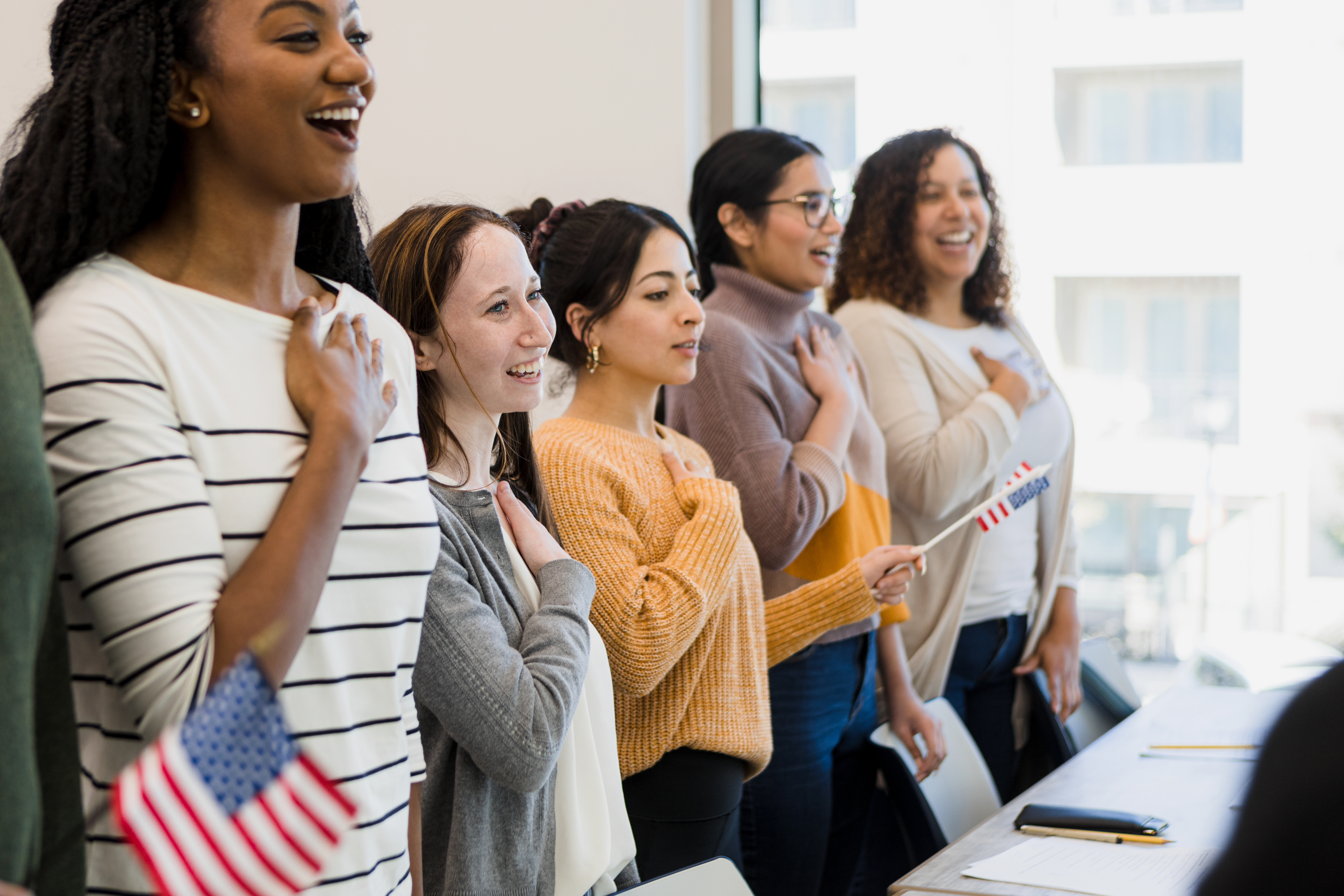 Several women with hands over heart US pledge
